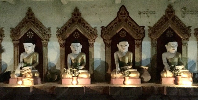 Random, candlelit roadside Buddhas.