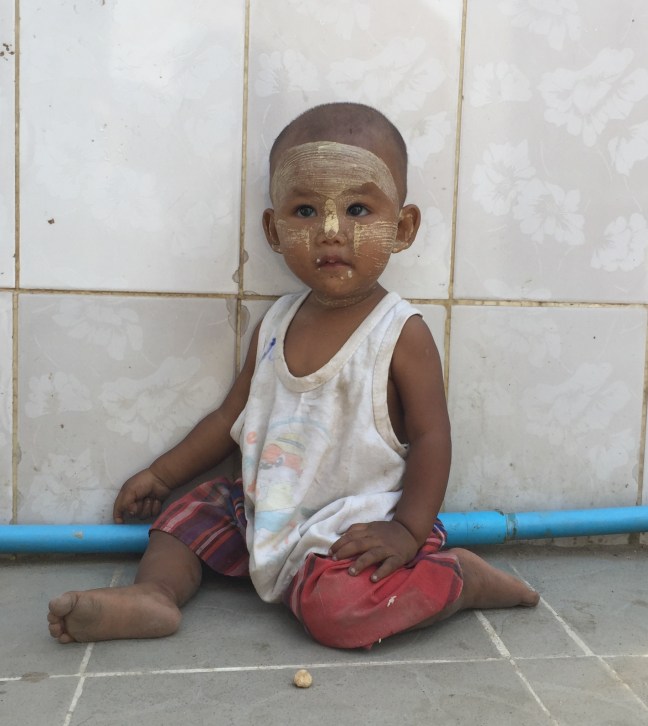 This sweetheart, wearing traditional face paint. 
