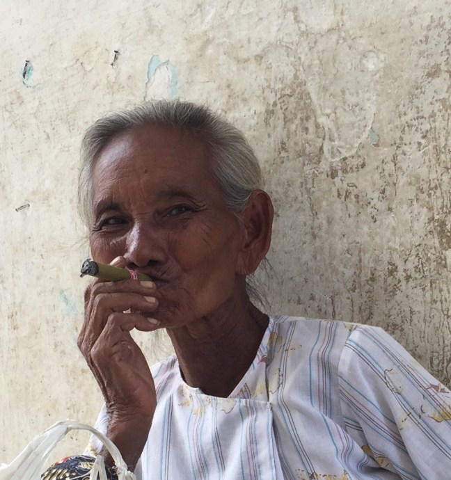 This woman would not stop smiling at me. When I motioned about taking her picture she grinned and nodded and then stuck the big cigarette in her mouth for me. I think I love her. 