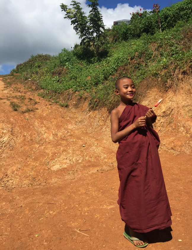 Young monk and a lollypop. How cute!