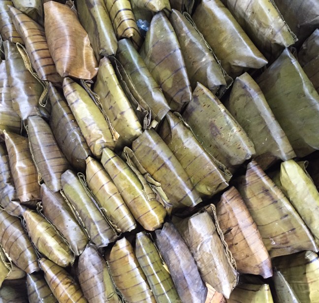 Rice-something or other wrapped in banana leaves.