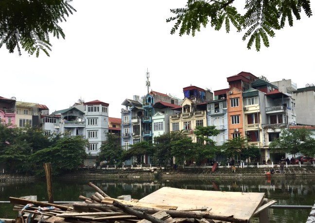 Typical housing... tight four story buildings nestled together, looking down on a river front where people walk, fish or just chill.