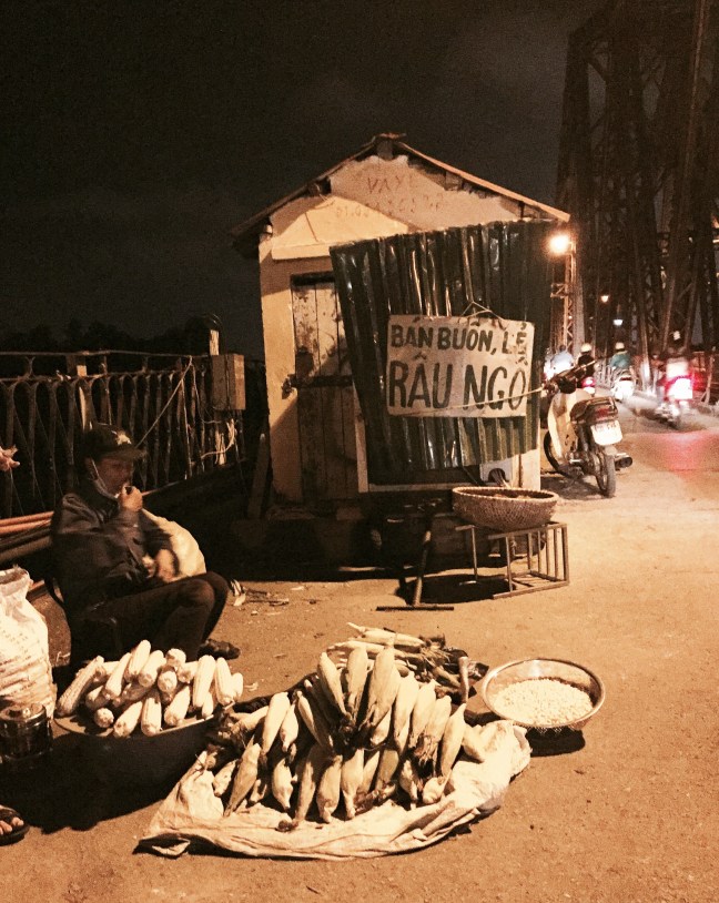 Roadside, roasted corn on the historic Long Bien Bridge.