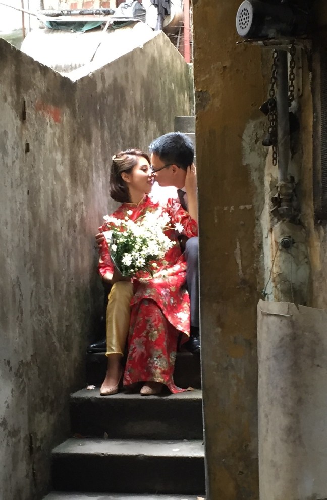 I stumbled upon this in one such hidden alleyway. Engagement photo, I assume? They are big on formal photography for every major life event here. 