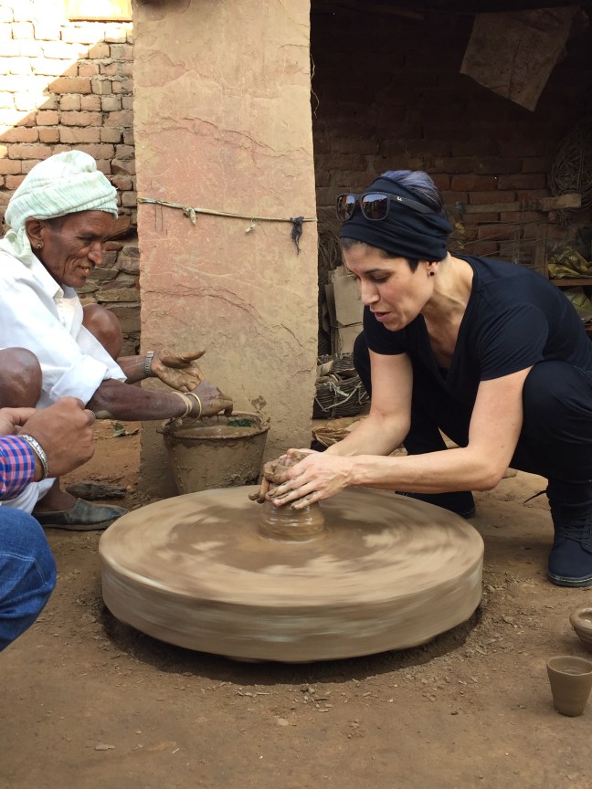 Annabell, having dabbled in pottery, jumped in and got her hands in the clay.