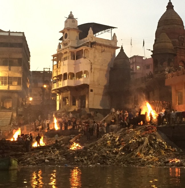 As seen from the river, several fires burning at once.
